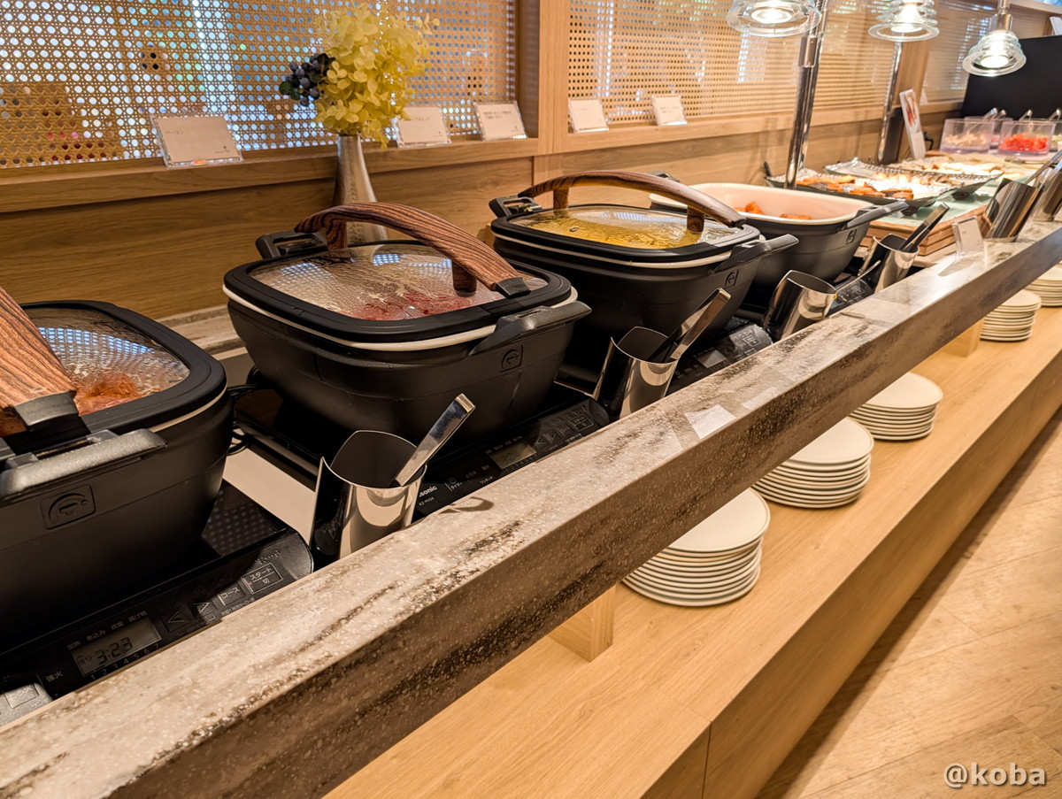 ホテルハーヴェスト勝浦の朝食ビュッフェ。カウンターにずらりと並んだ和洋様々な料理の雰囲気。